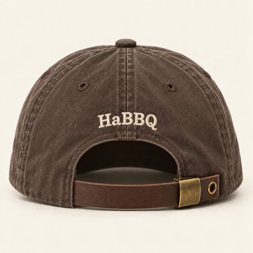 Espresso Dad Hat in espresso with warm cream embroidery, back view with the small HaBBQ mark above the leather strap and buckle