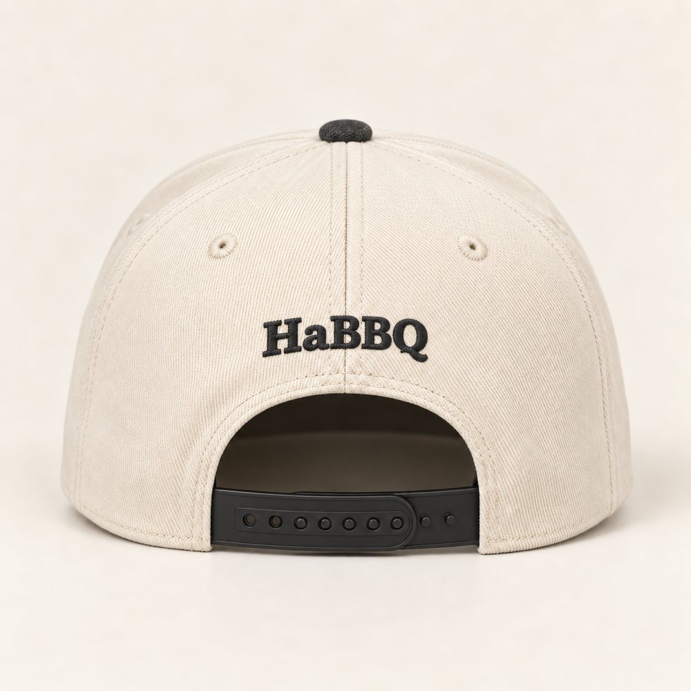 Natural / Coal Two Tone Cap in a natural crown, coal brim and coal embroidery, back view with the small HaBBQ mark above the plastic snapback