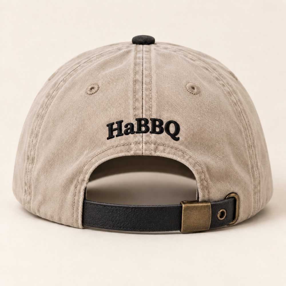 Stone / Black Dad Hat in a stone crown, black brim and black embroidery, back view with the small HaBBQ mark above the leather strap and buckle