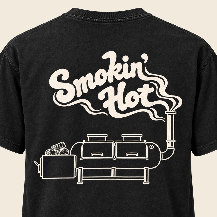 Close up of the Smokin' Hot offset smoker graphic printed across the back of a black HaBBQ tee